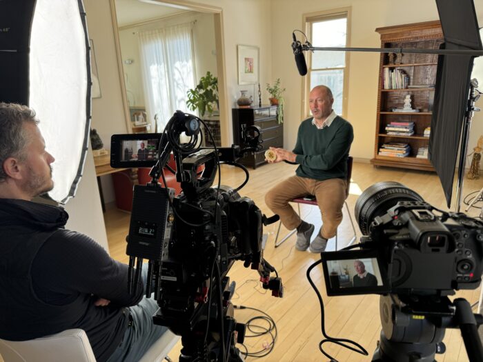 A close angle of a professional video production company interviewing a subject.